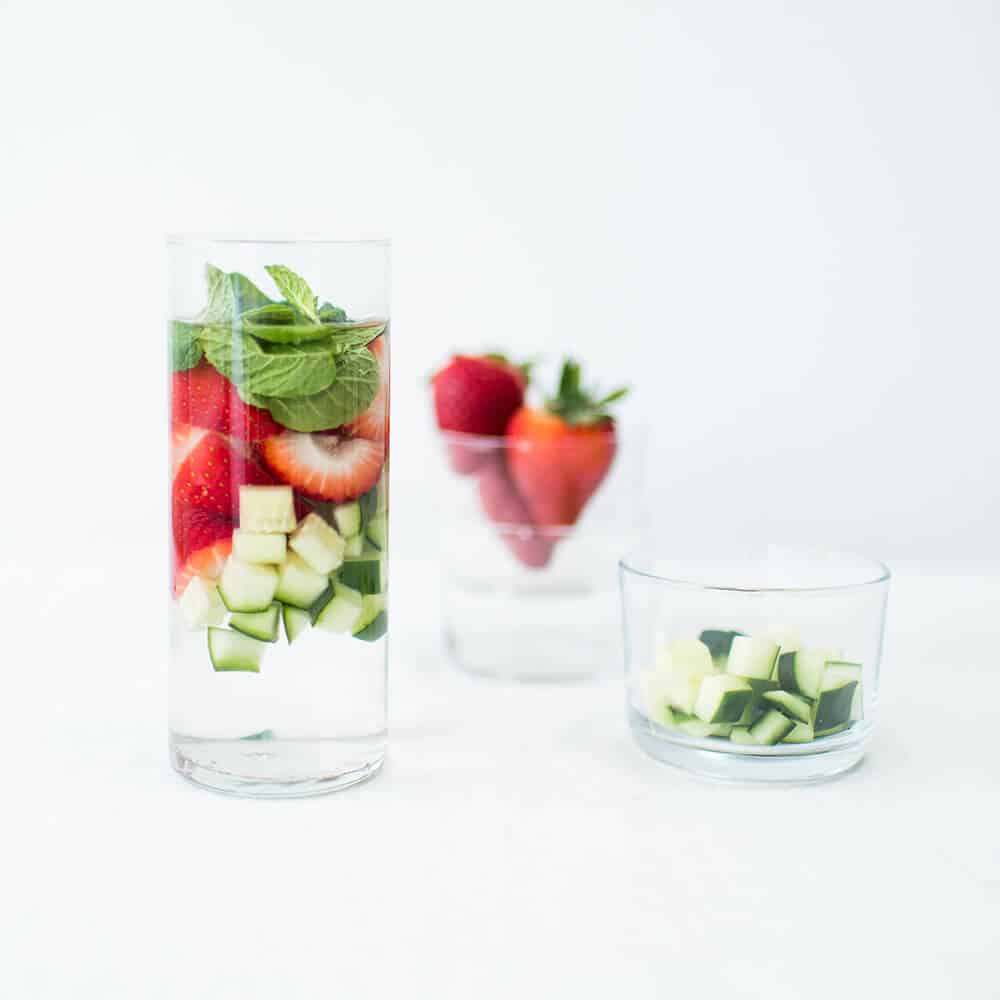 Glass of spa water with strawberries and cucumbers